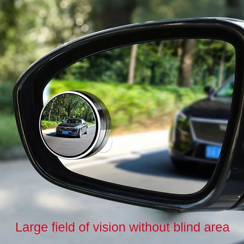 A close-up view of a black car mirror showing a wide field of vision without blind spots.