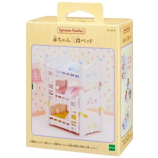 A cardboard box containing a Sylvanian Families Forest Friends gift set featuring a wooden crib and accessories.