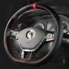 A black steering wheel with red stitching and a central airbag cover.