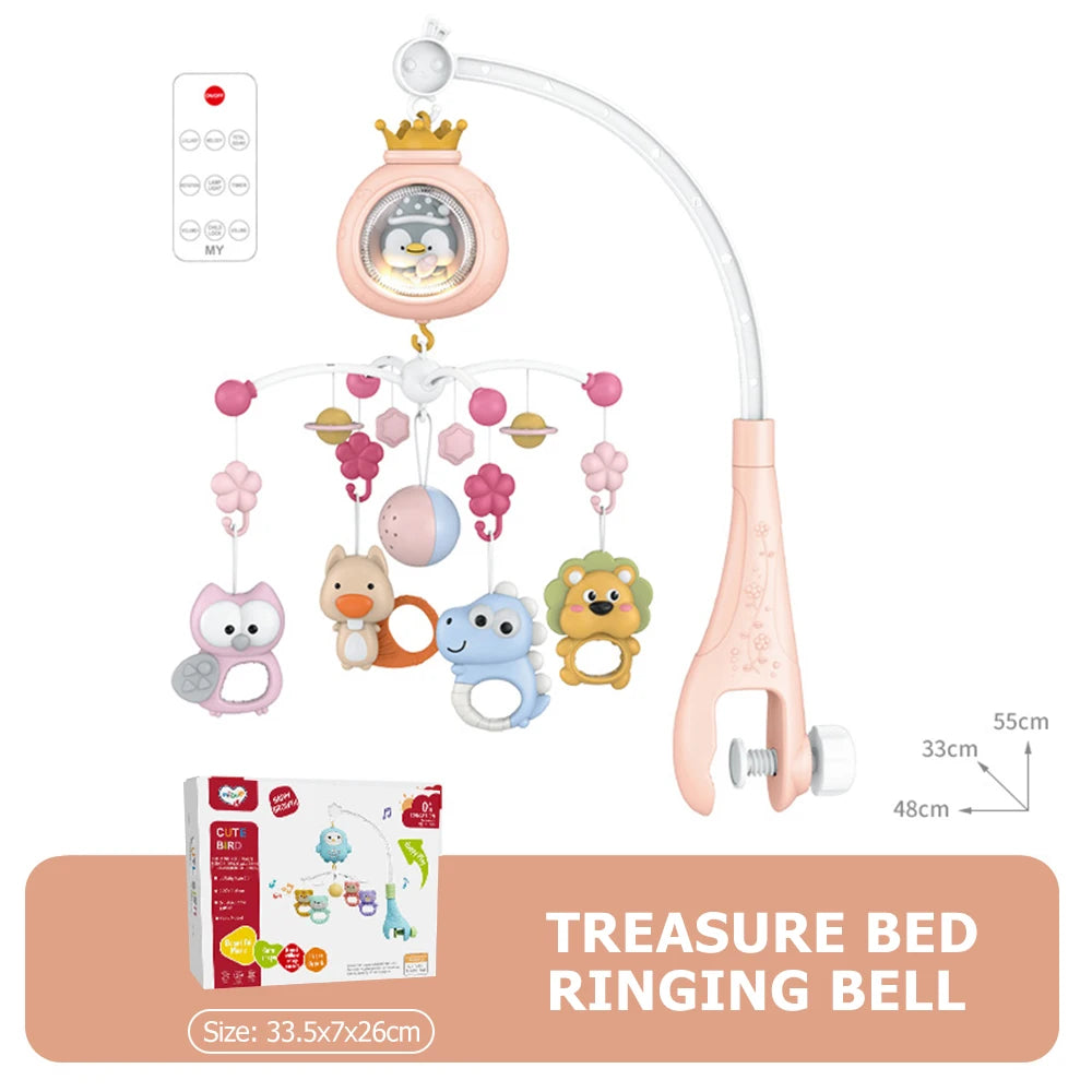 A pink treasure bed ringing bell mobile featuring a crown, various hanging toys, and a light fixture.