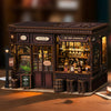 A detailed wooden dollhouse miniature assembly kit featuring a facade with glass windows and internal lighting.