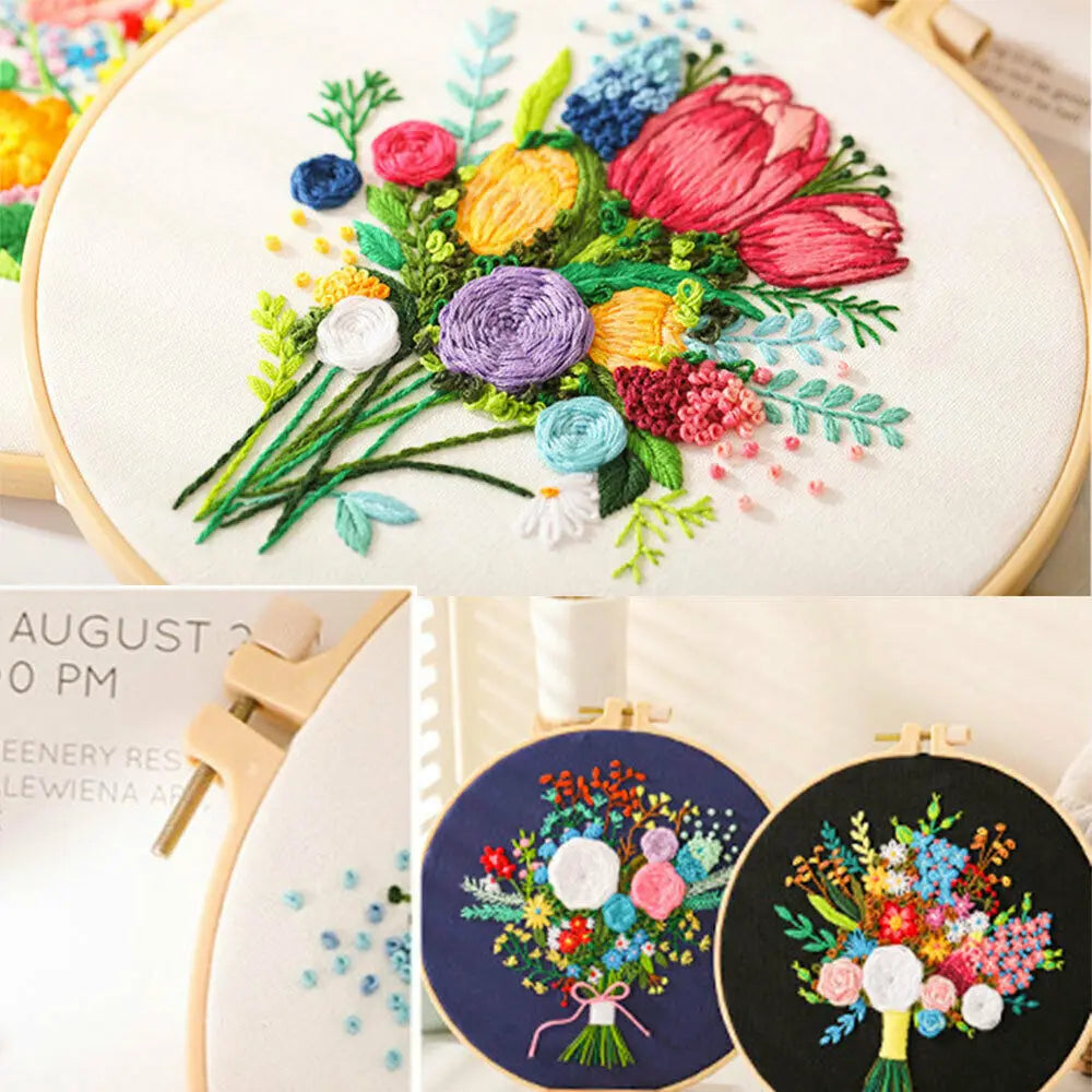 A close-up of a floral cross stitch embroidery kit showing various colored fabric flowers and greenery on white linen.