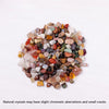 A pile of mixed natural crystal gravel stones showing various colors including pinks, reds, greens, and browns.