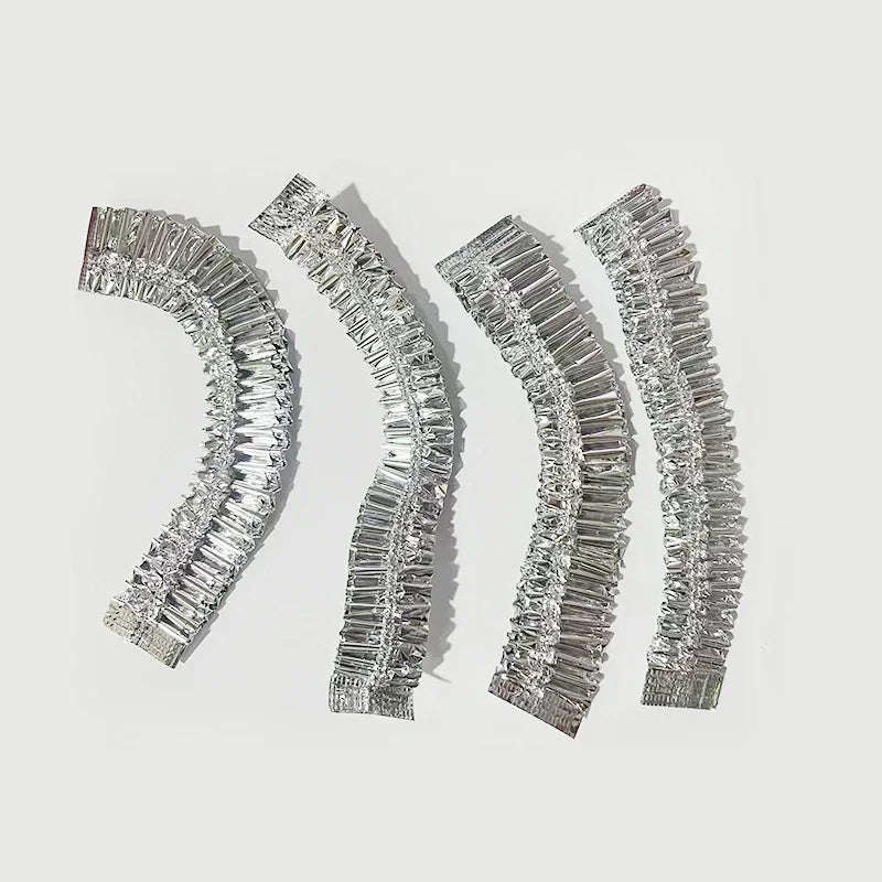 Four silver aluminum foil bowl covers with textured edges displayed against a white background.