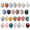 A collection of various colored organic cotton muslin baby bibs with absorbent bands