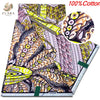 A close-up view of a pink glitter African wax print fabric featuring intricate patterns and designs.