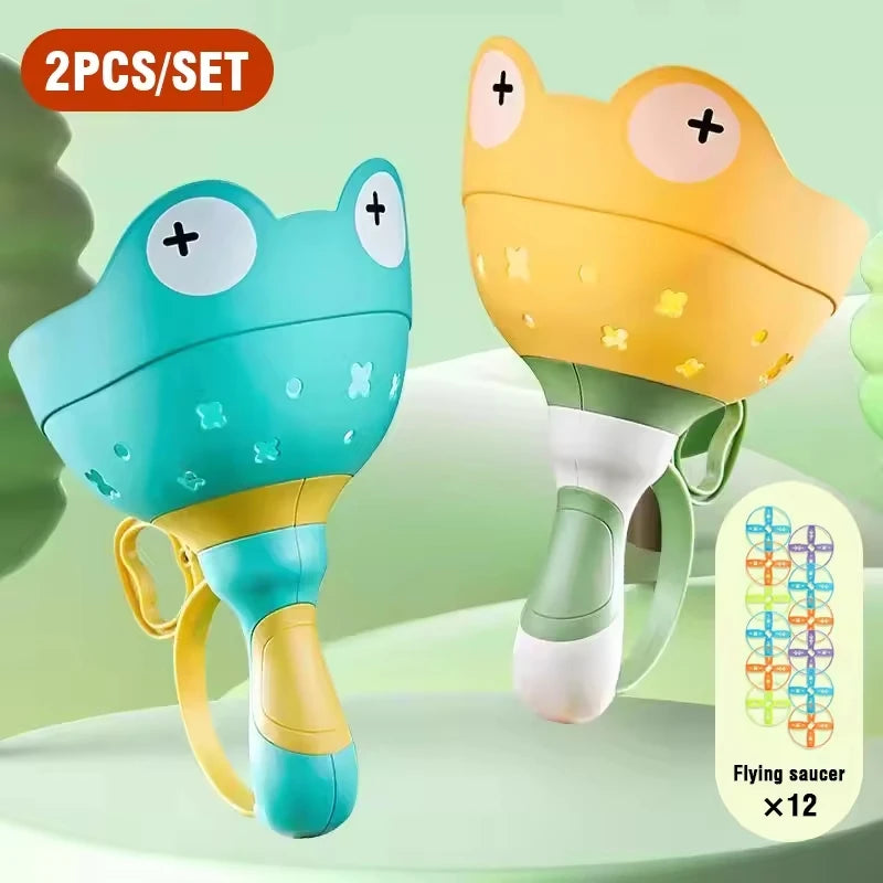 A set of two pull-string flying saucer launcher toys for kids, one teal and one yellow.