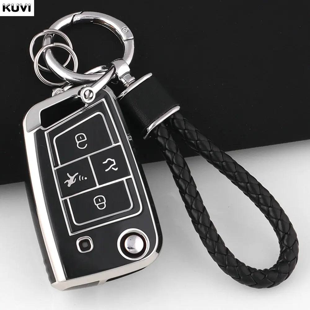 A silver TPU car key fob cover with a black strap is shown against a dark background.