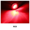 A bright red LED light beam shining forward from a round marker light.