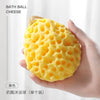 A hand holds a yellow bath ball cheese made of soft mesh for baby