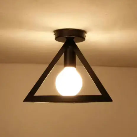 A black metal frame ceiling lamp with a single glowing light bulb.