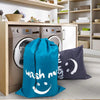 A collection of large drawstring laundry bags in various colors and designs, including teal, blue, and black, used for laundr