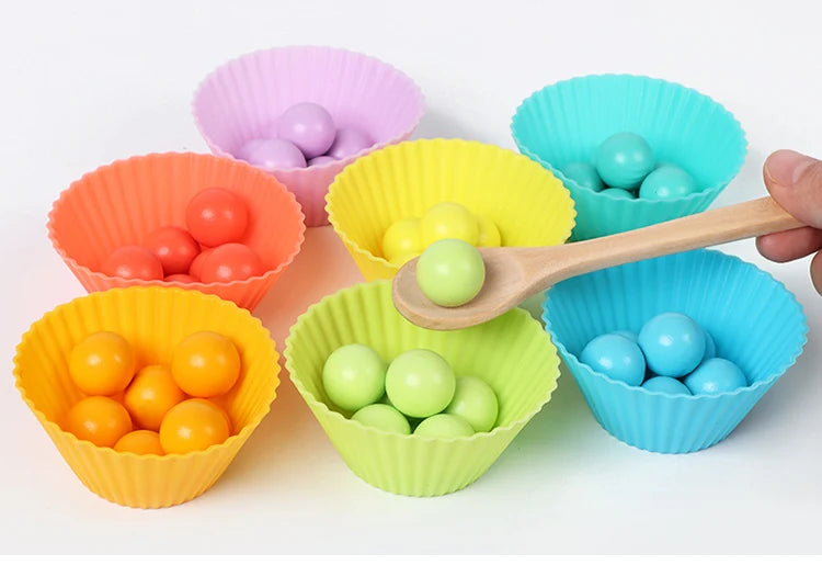 Colorful plastic muffin cups filled with wooden beads and a wooden spoon for a Montessori bead maze puzzle