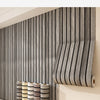 Vertical wood grain wallpaper installed on a wall, with cylindrical decorative rods displayed below.