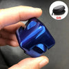 A hand holds a shiny blue alloy metal fidget cube spinner with a black gift pouch nearby.