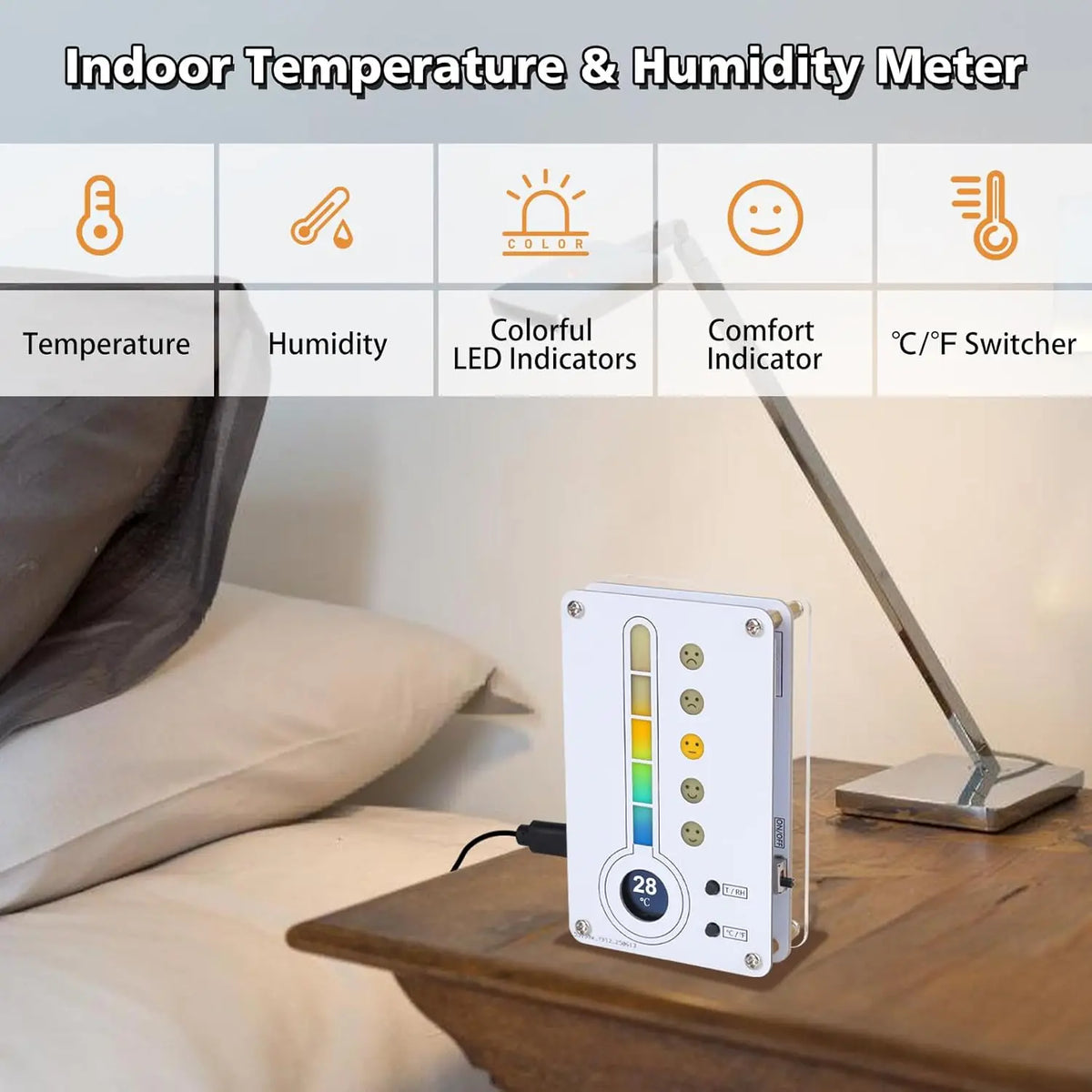 A white digital indoor temperature and humidity meter device is displayed on a wooden table next to a bed.
