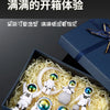 A set of handcrafted astronaut figurine resin spacemen displayed in a blue box with shredded yellow material.