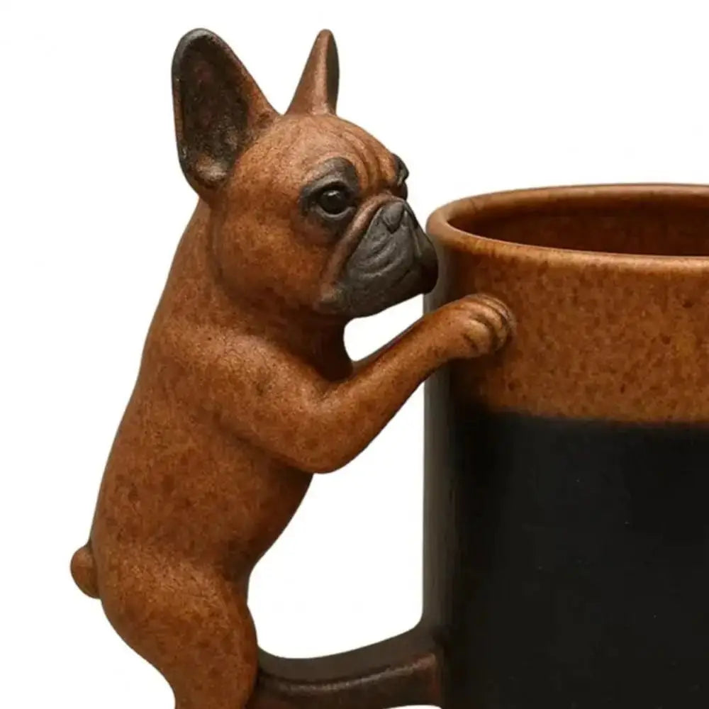 A terracotta-colored dog figurine with an outstretched paw is attached to a black coffee mug.