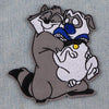 An embroidered patch featuring a stylized cat dragon design with gray, white, and blue elements.