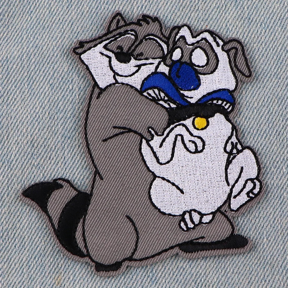 An embroidered patch featuring a stylized cat dragon design with gray, white, and blue elements.