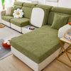 A light green stretch jacquard sofa cover featuring a leaf pattern on a modern sectional sofa.