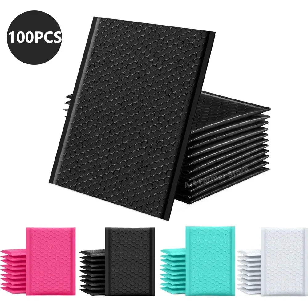 A collection of black and pink bubble mailers, including a stack of 100 black padded self-seal shipping envelopes.