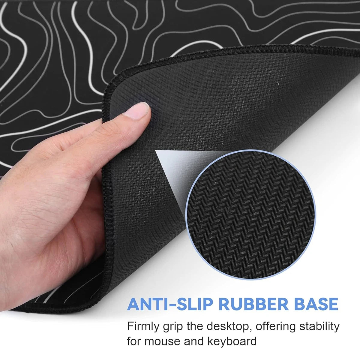 A hand is holding a black mouse pad with an anti-slip rubber base, showing its texture and grip.