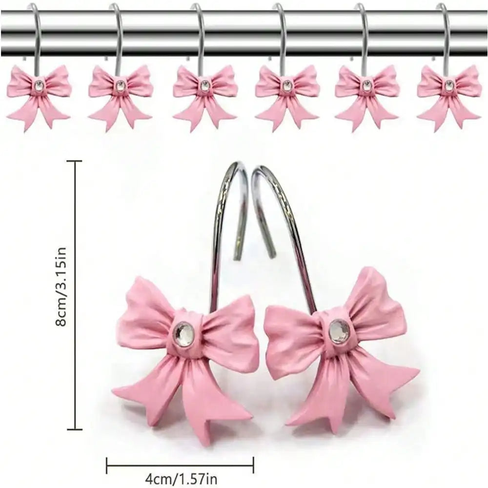 A set of twelve pink decorative bow tie shower curtain hooks with silver hangers.