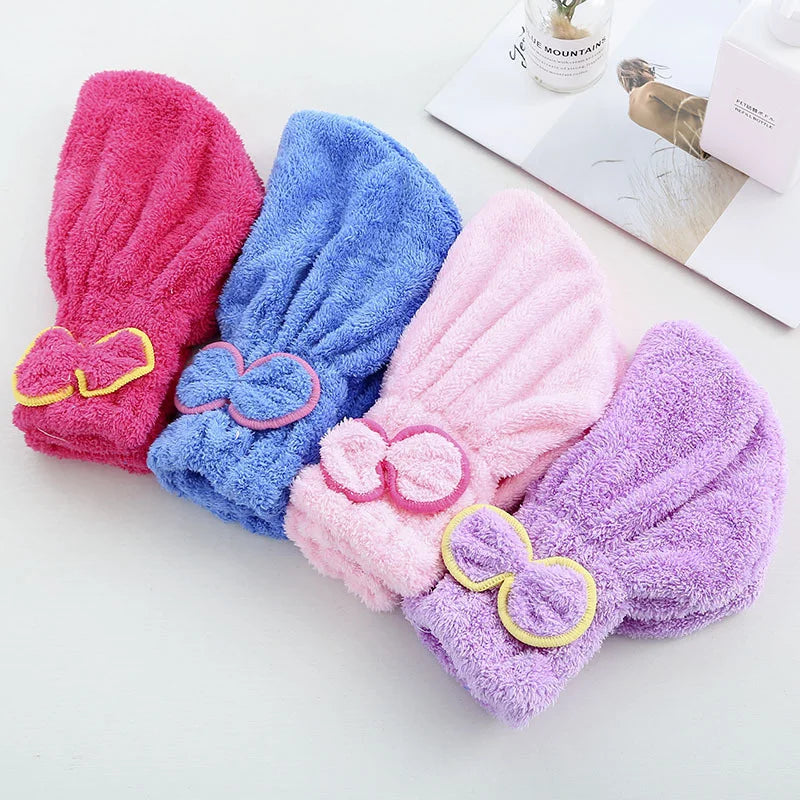A set of three microfibre quick-dry hair towel wraps in pink, blue, and purple with bow knots.