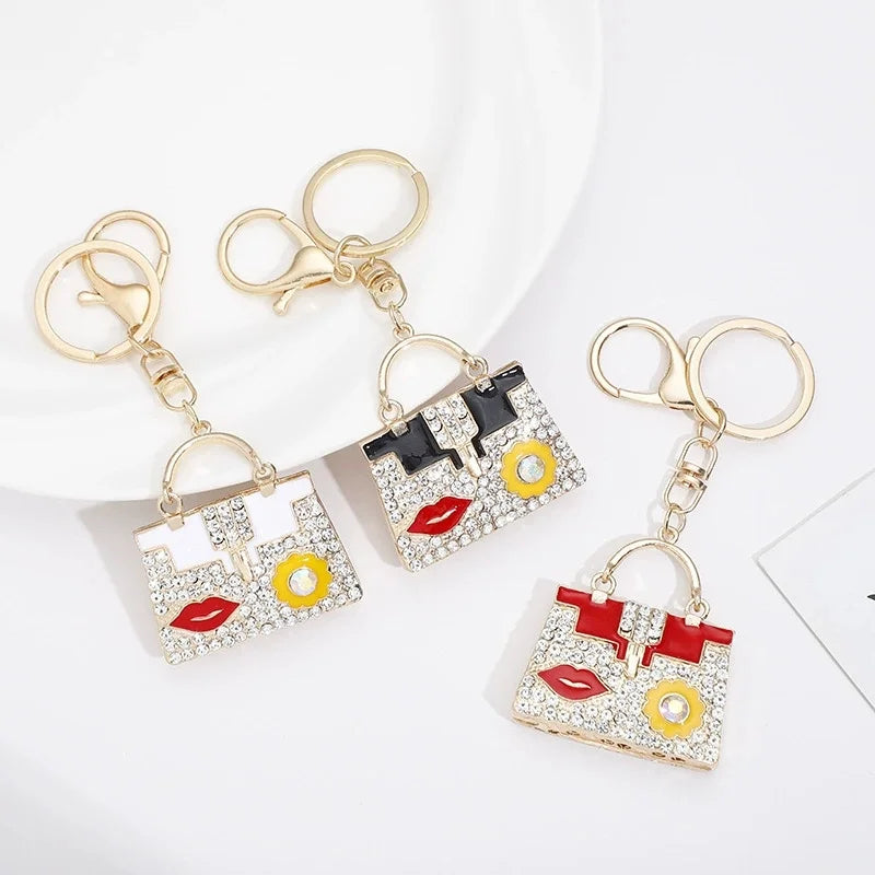 Gold-toned crystal rhinestone handbag keychain with a square design and a gold split ring.
