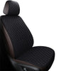 A close-up view of a black quilted car seat cover set with brown accents.