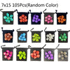 A set of 105 random color polyhedral dice stored in individual black fabric bags.