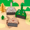 A set of three compact cartoon brooms and a dustpan for tabletop cleaning, featuring woodland animal designs.