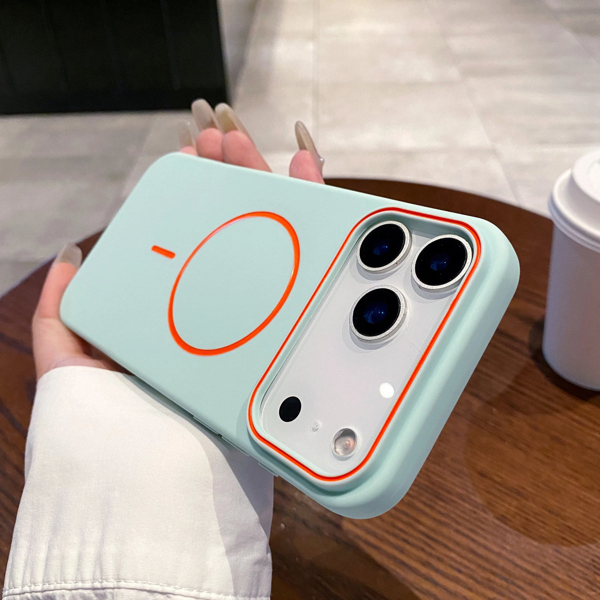 A light mint green Magnetic Matte phone case with MagSafe support is held in a person's hand.