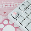 A white plastic case containing pink silicone cat paw and heart keycaps for MX switches
