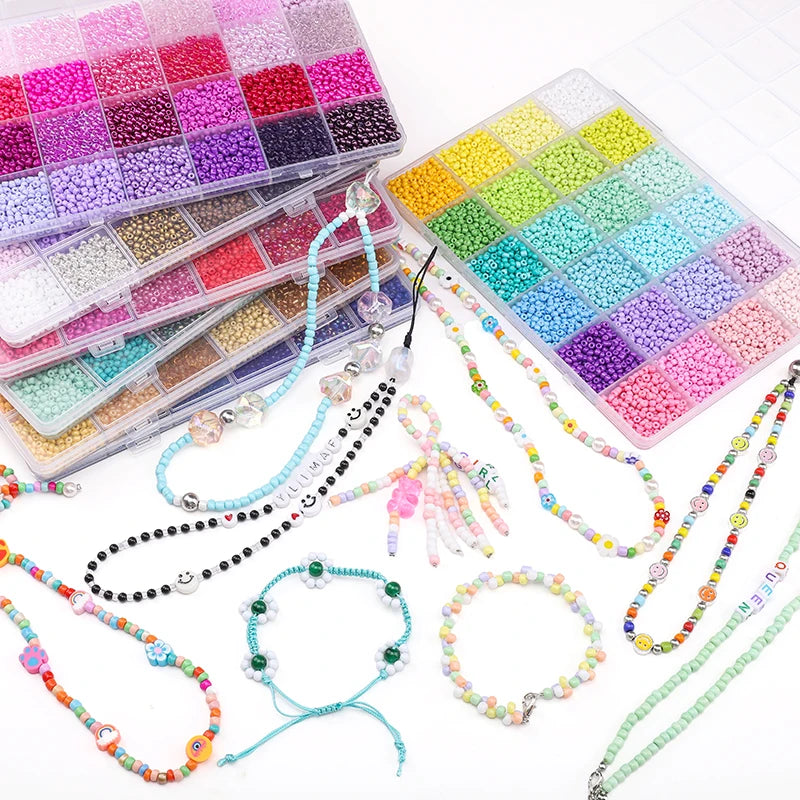 A variety of colorful glass rice beads and stringing materials are displayed in various colors and quantities for jewelry mak