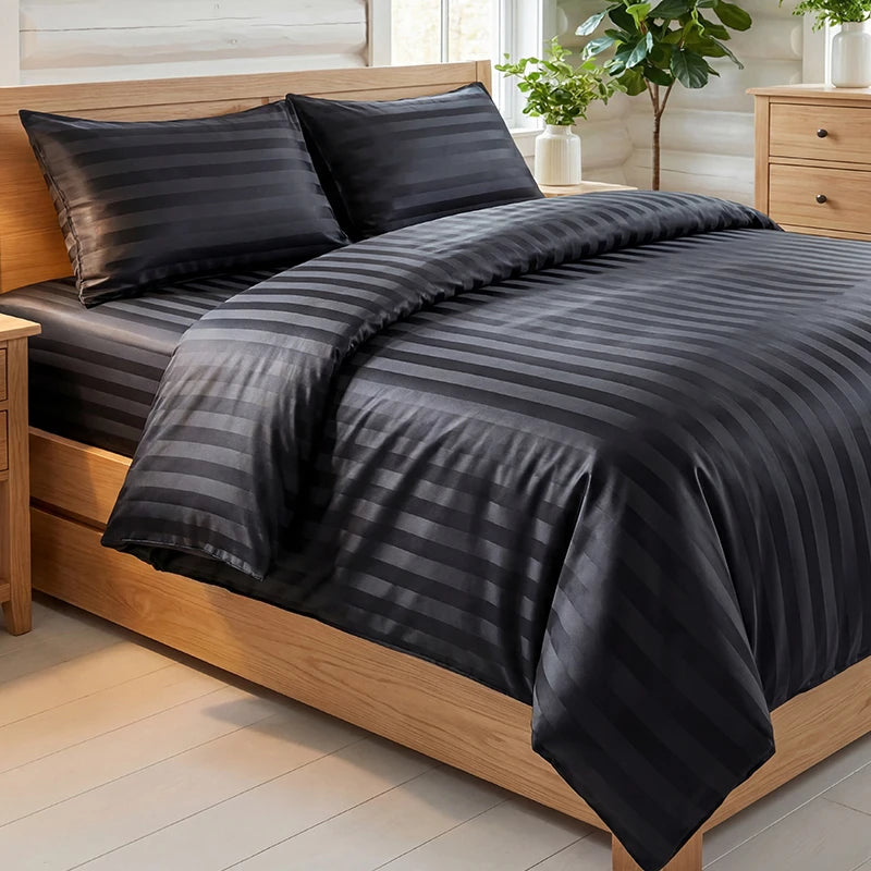A dark gray satin striped jacquard duvet cover set displayed on a wooden bed with matching pillows.