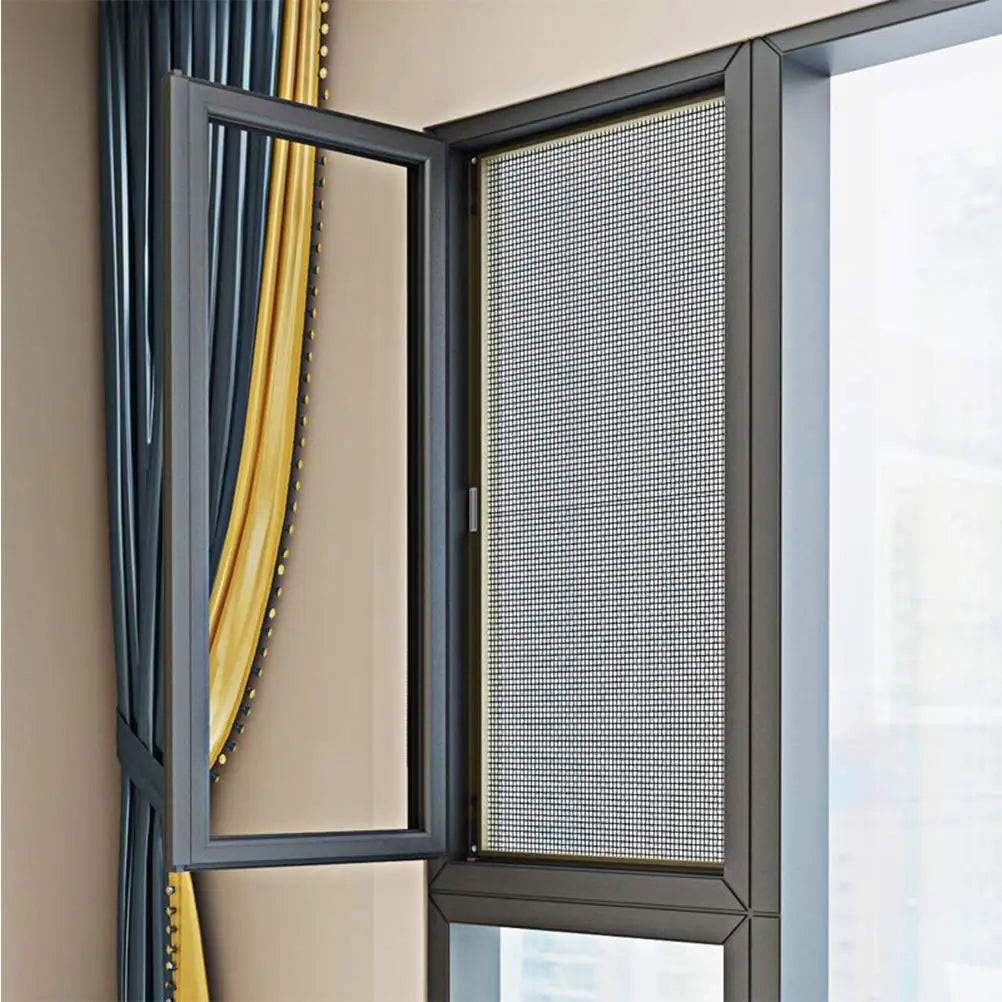 A close-up view of a dark gray mesh screen installed in a window frame with yellow curtains visible.