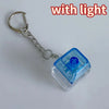 Silver chain keychain with a blue LED light and custom keycaps