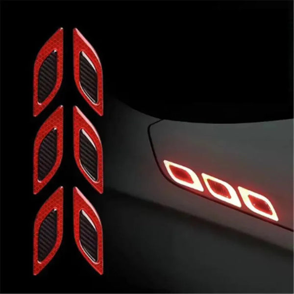 Close-up view of reflective safety strips mounted on a dark vehicle surface.