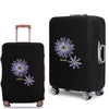 Black elastic suitcase with a daisy print design featuring purple and yellow flowers.