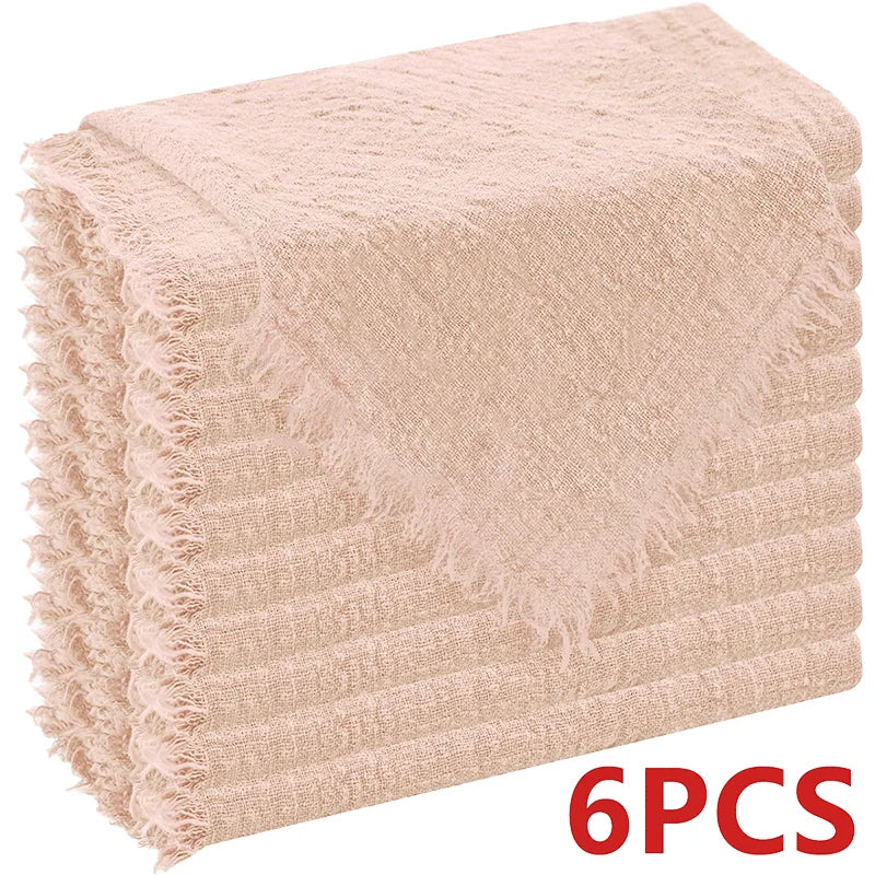 A stack of six raw-edge, light pink polyester cloth napkins.