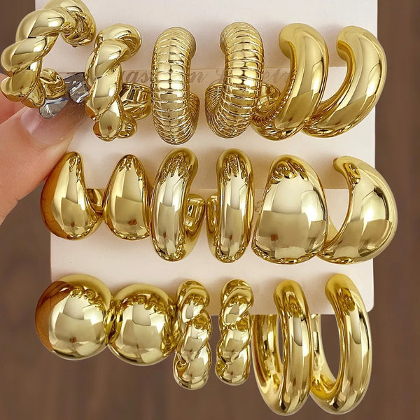 A set of vintage gold plated hoop earrings displayed on a white card.