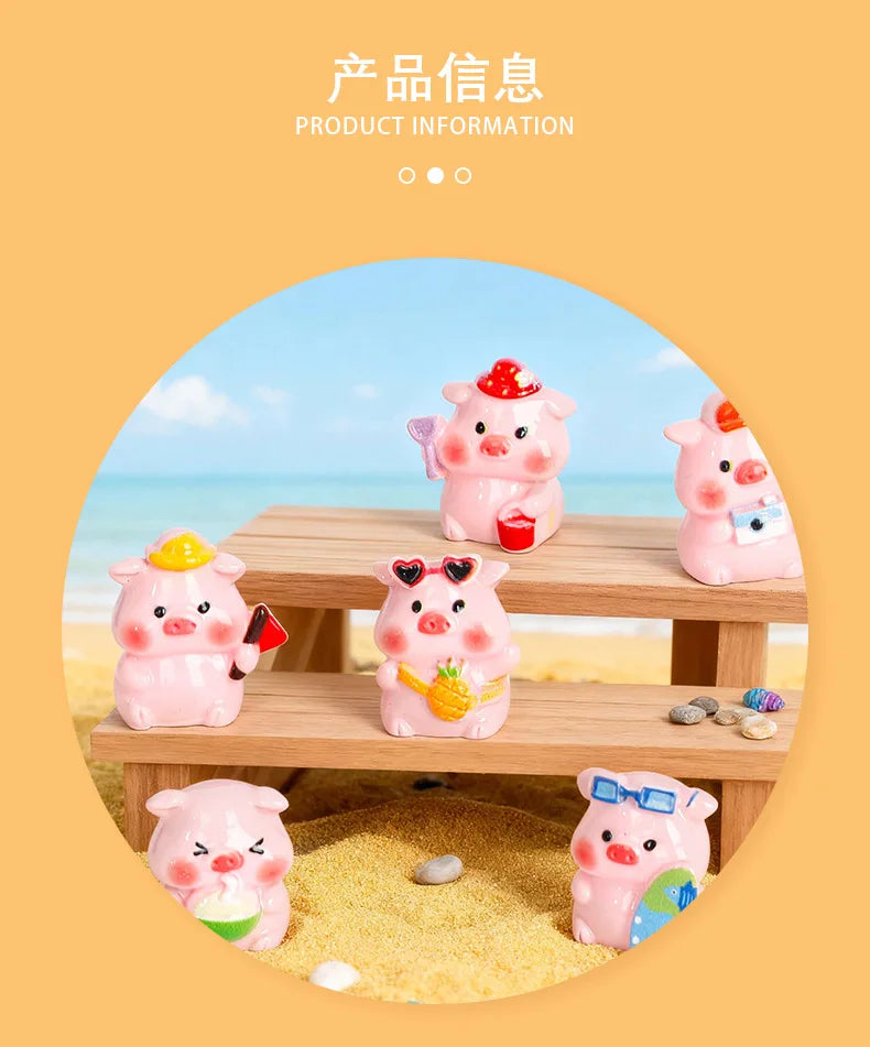 Pink resin pig figurines in various poses displayed on a wooden surface with yellow sand and small stones.