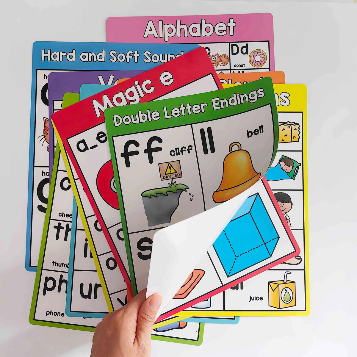 A stack of colorful phonics learning cards featuring letters, sounds, and word endings for early readers