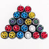 A collection of ten pairs of 1:64 scale alloy car wheels and tires in various colors including red, blue, yellow, and black.