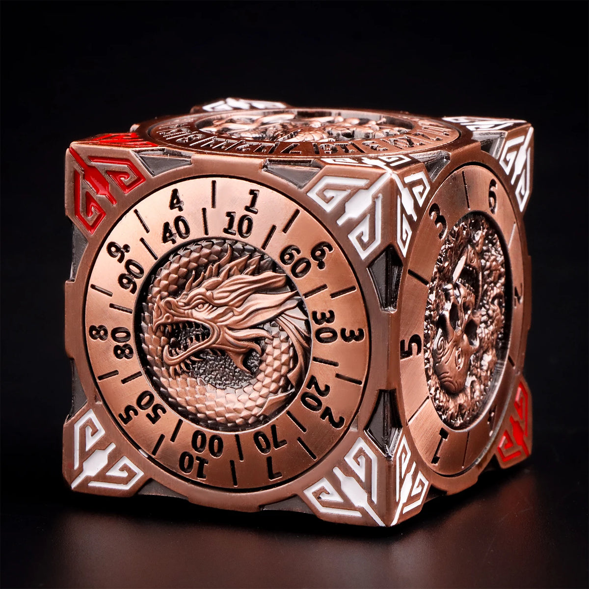 A bronze metal spinner dice cube featuring a dragon design and numbered faces, displayed on a dark surface.