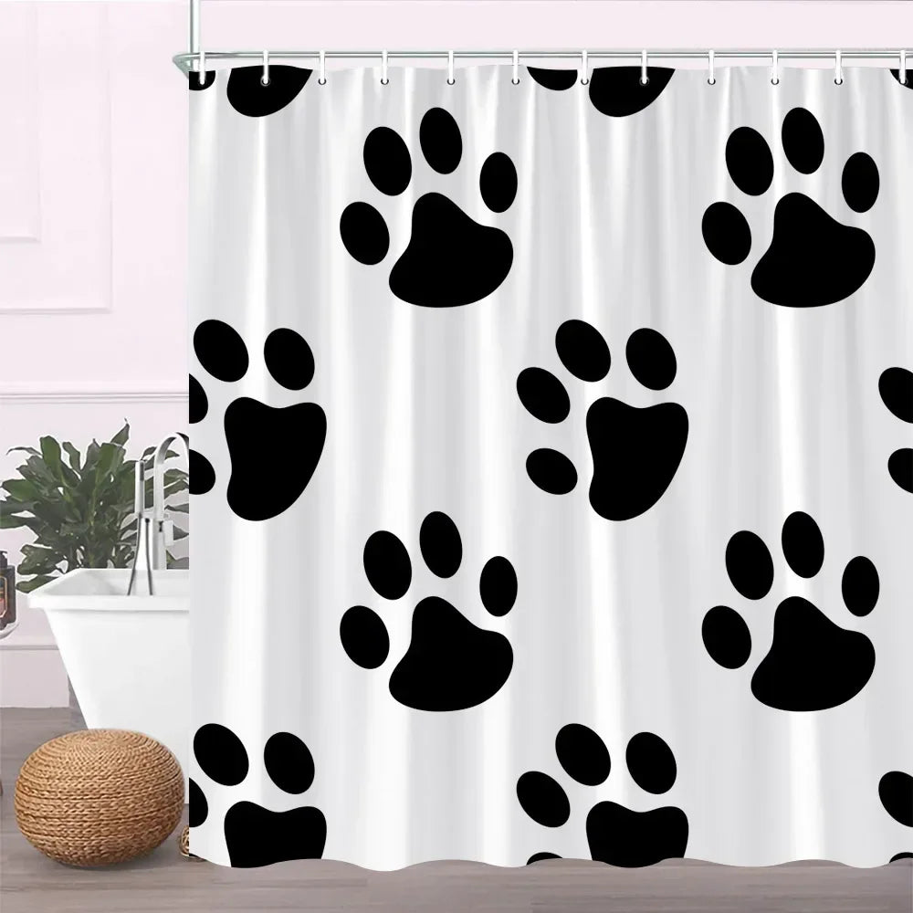 A white fabric shower curtain featuring a repeating pattern of black paw prints.