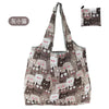 A patterned tote bag featuring cute cat designs in shades of gray and brown.