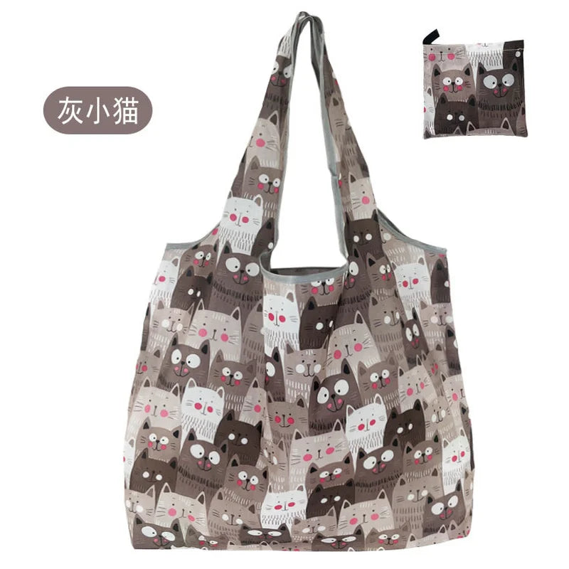 A patterned tote bag featuring cute cat designs in shades of gray and brown.